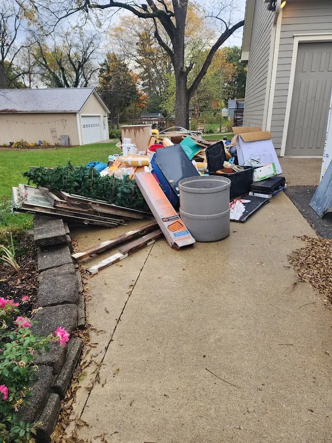 Dumpster being loaded with debris for Estate Cleanout Dumpster Rental in Park Layne